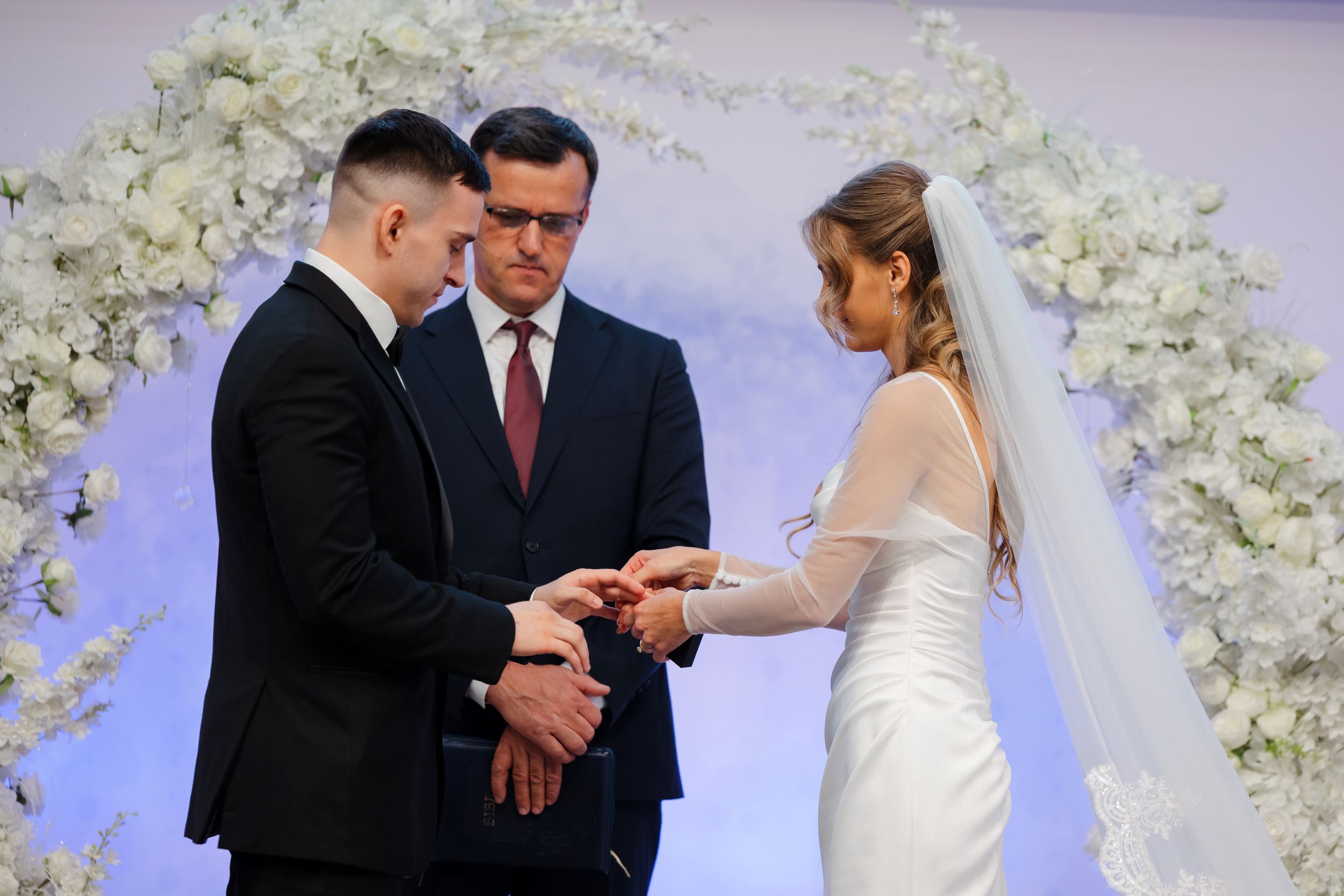 Bride and groom exchange rings during Ohio wedding ceremony photographed by Tom Forrest from Hudson, Ohio.