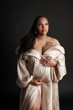 Artistic boudoir photography series featuring a model in a cream-colored silk robe against a dark background.