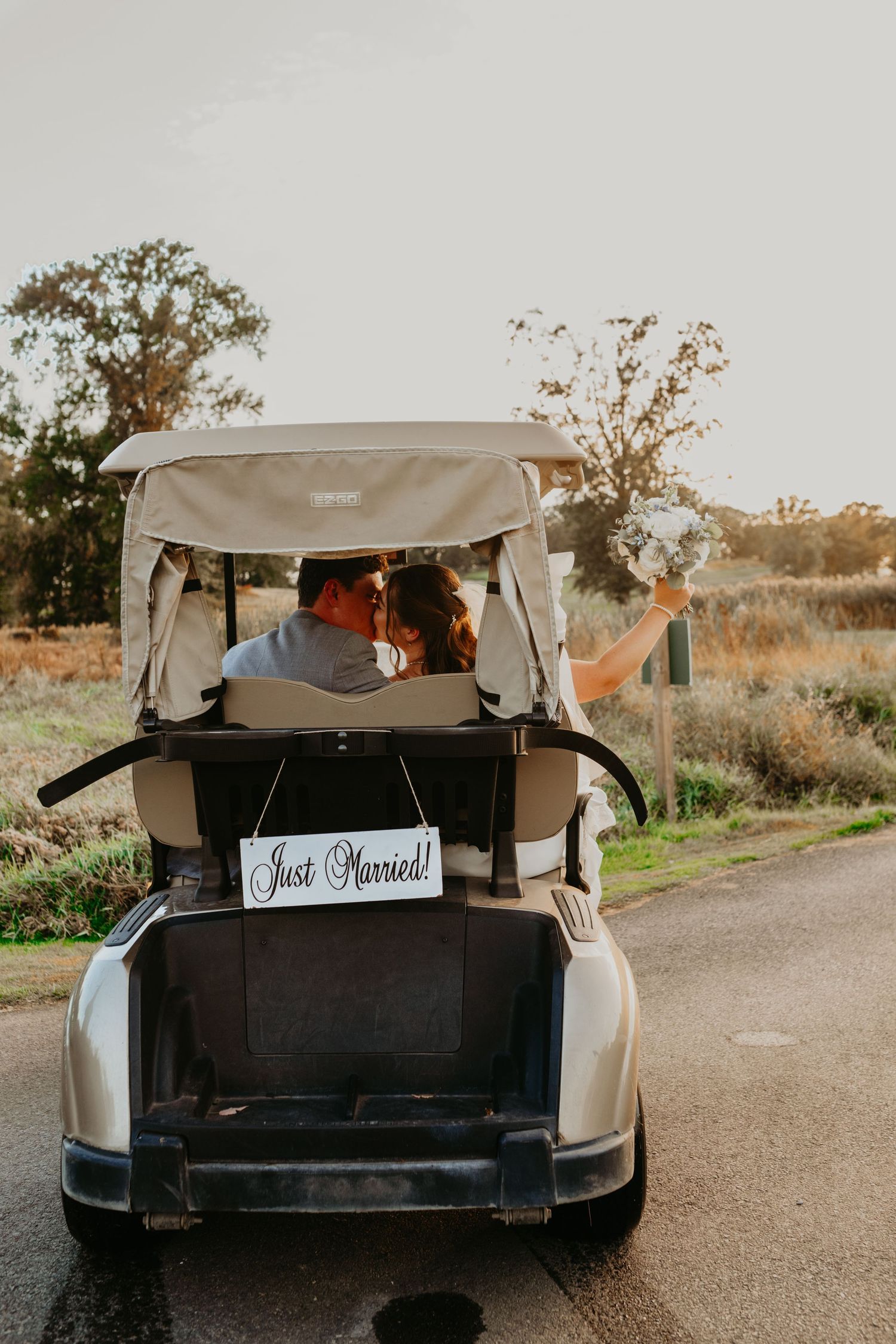 Bride and Groom Photo at a NJ golf course during the Fall Months with cathedral Veil  and golf Cart