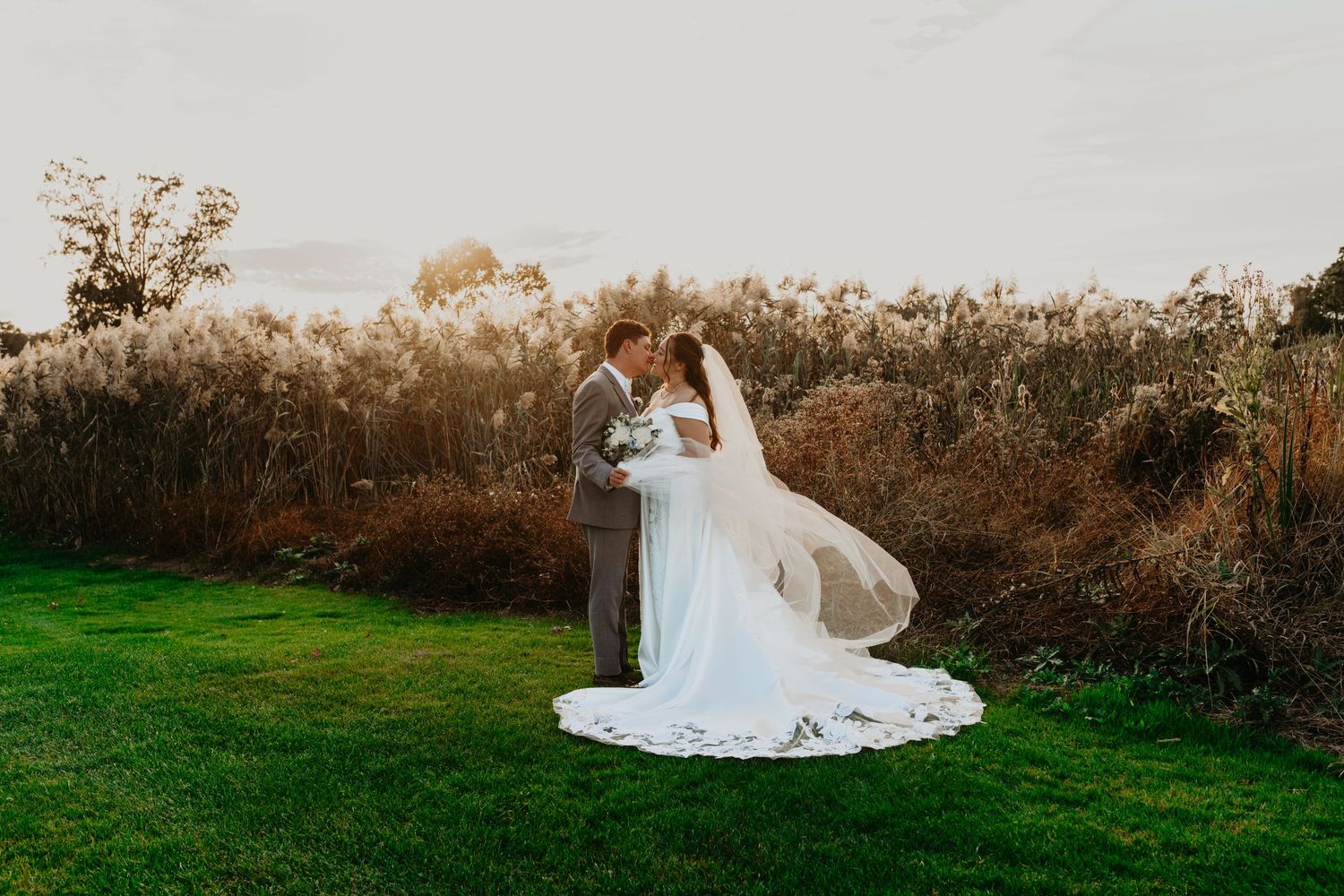 Bride and Groom Photo at a NJ golf course during the Fall Months with cathedral Veil