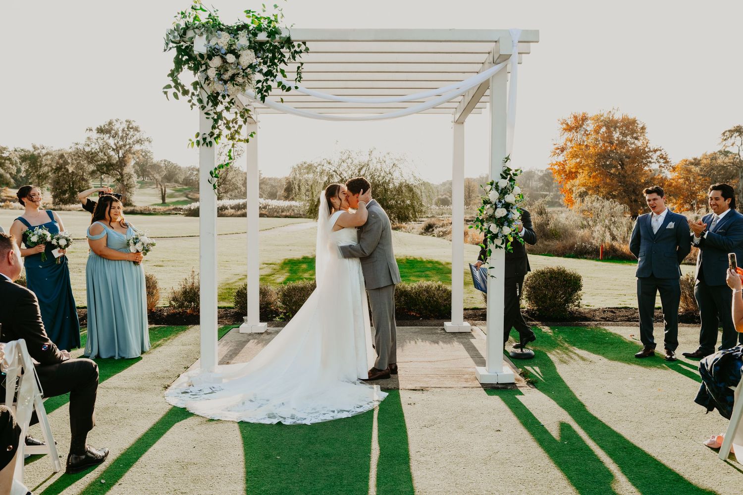 Bride and Groom Photo at a NJ golf course during the Fall Months with cathedral Veil