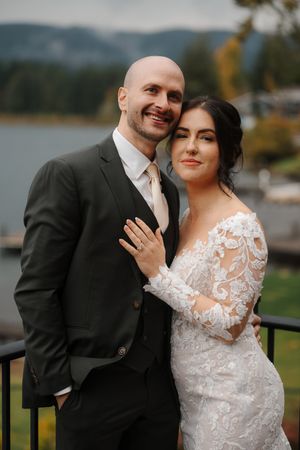 A romantic wedding photo series showing a couple embracing outdoors with mountains and fall foliage in the background.
