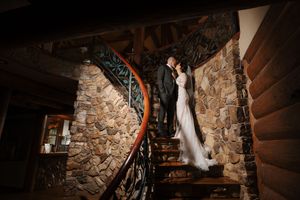 Stone-walled wedding ceremony space with dramatic lighting and wooden accents creating an intimate ambiance.
