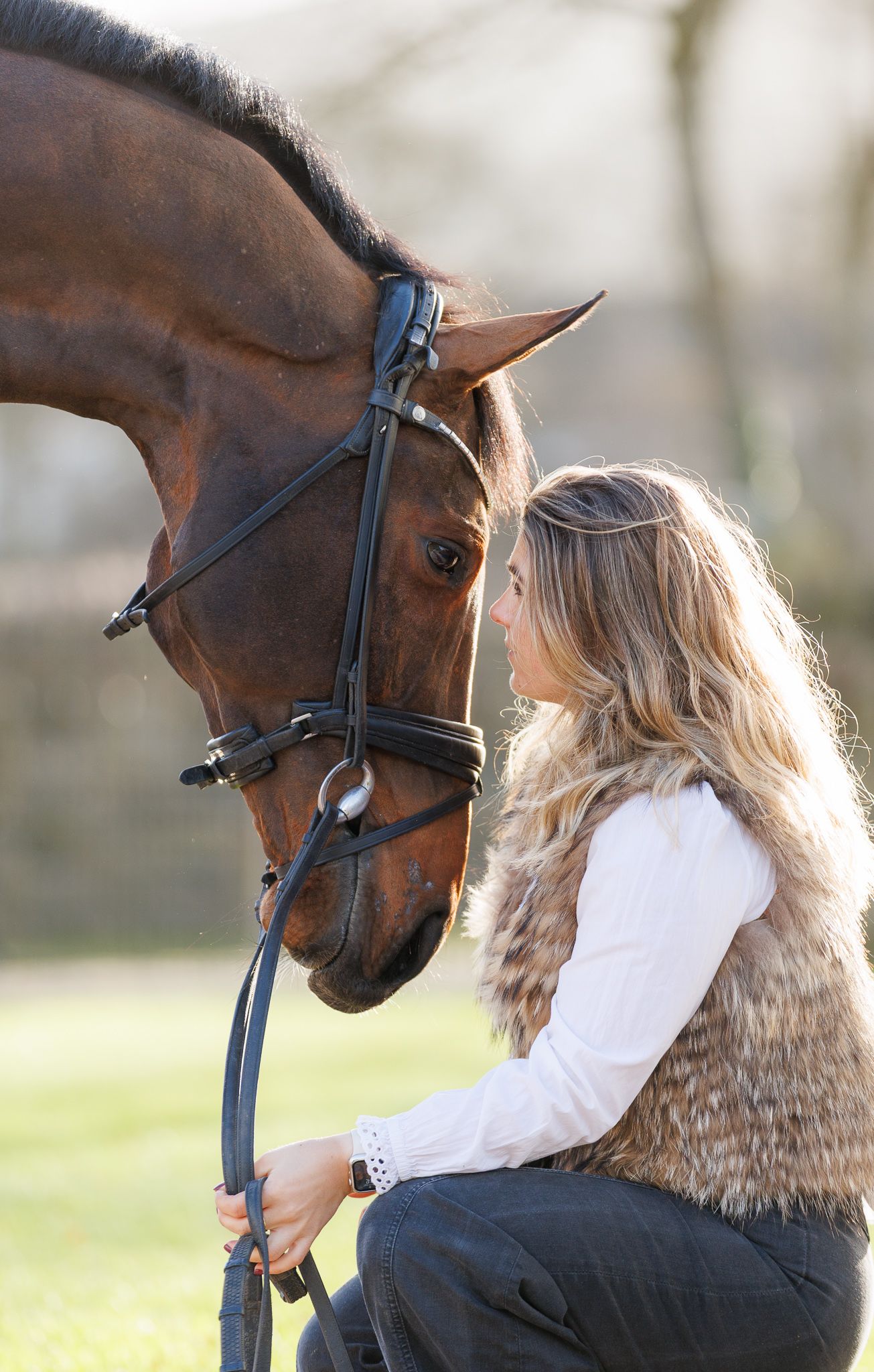 A series of photos showing a person with red hair interacting with a dark horse in a soft-focus outdoor setting.