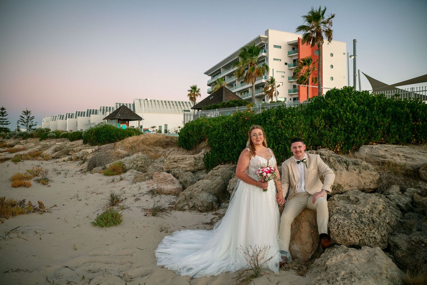 Bride and groom taking a swirl in the aisle with wedding guests cheerfully clapping