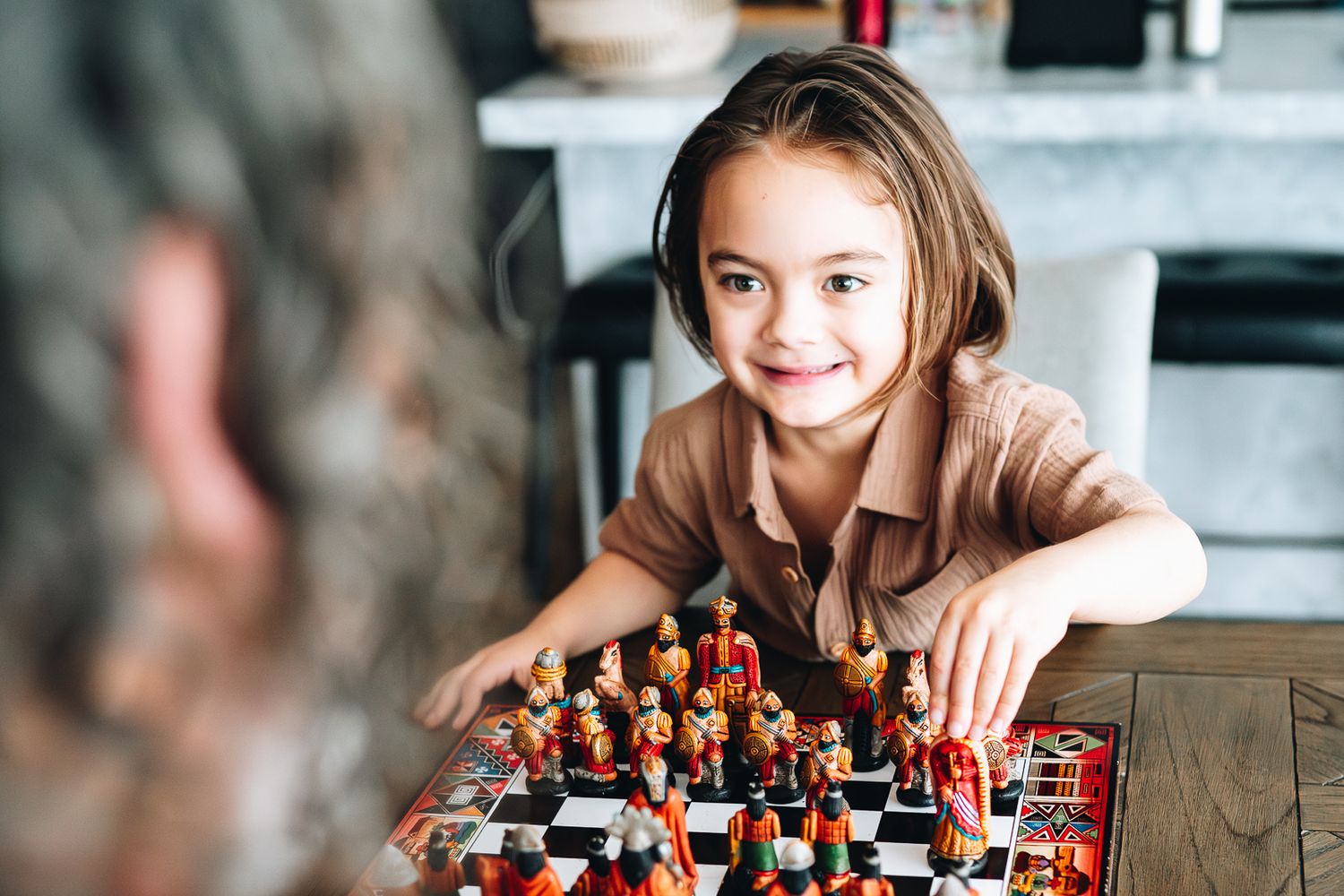 Father and son playing chess during a newborn and family photoshoot at home by Melbourne newborn and family photographer Pei A Photography