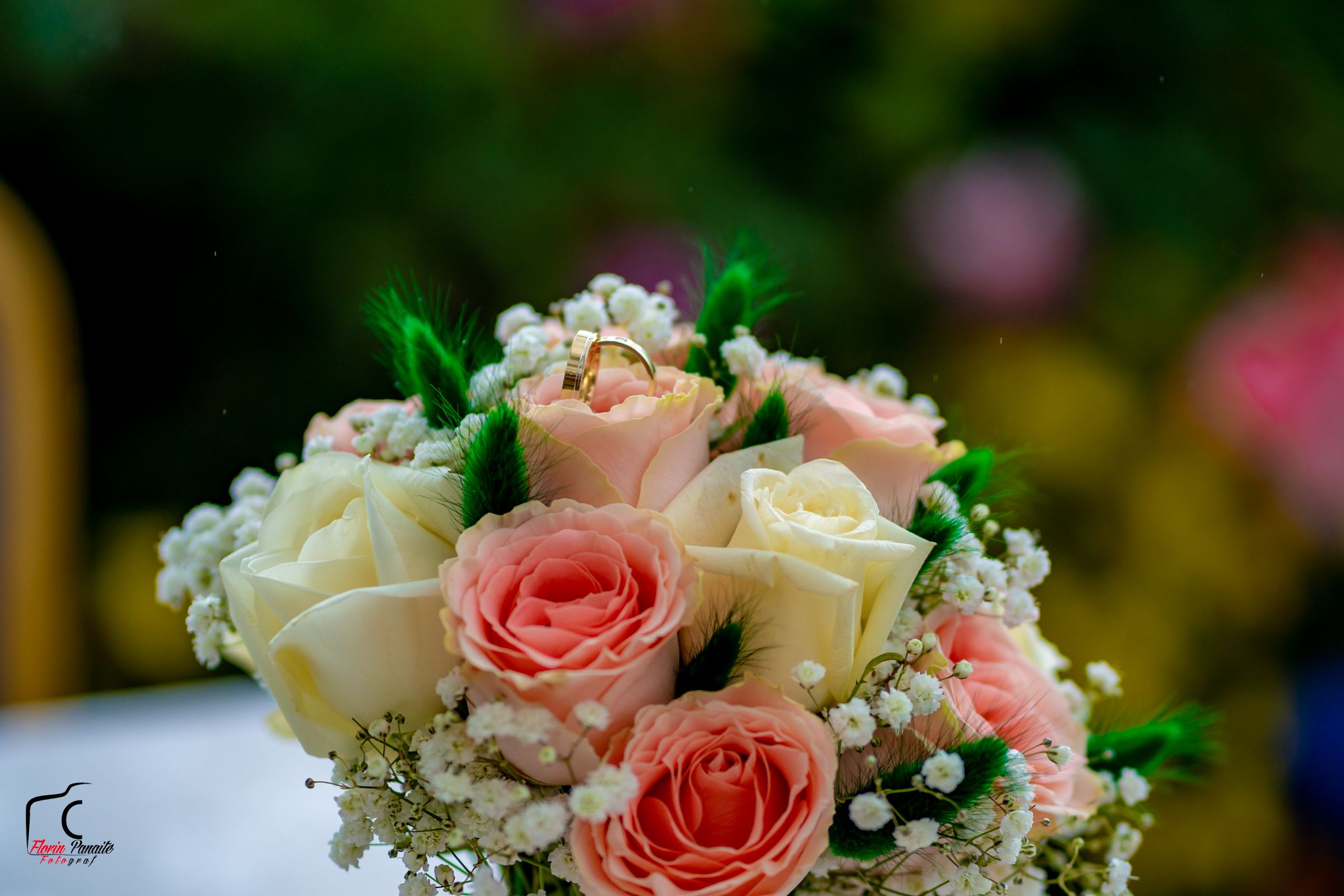 Romantic bouquet with pink and white roses adorned with delicate baby's breath flowers.