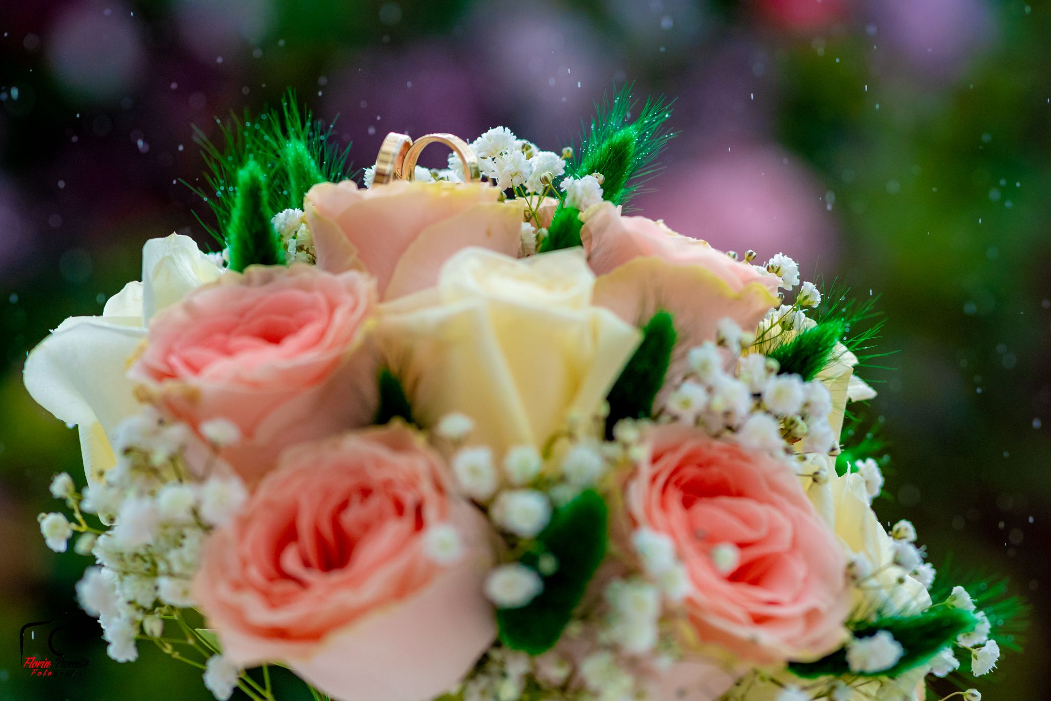 Fresh pink and cream roses mixed with white baby's breath flowers in an elegant floral arrangement.