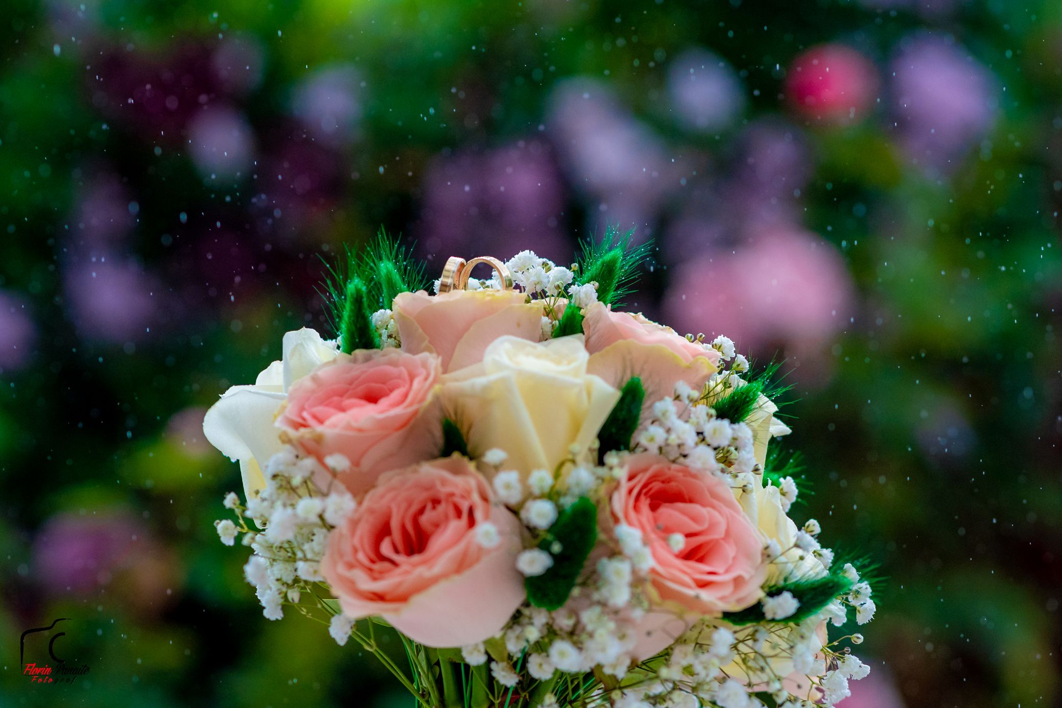 Romantic floral arrangement featuring pale pink roses and delicate white baby's breath flowers.