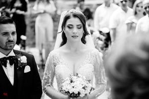 Black and white wedding ceremony photo capturing an intimate moment between the couple.