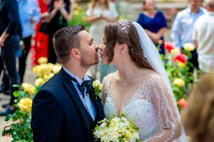 Romantic wedding scene in a garden with colorful flowers and elegant decor.