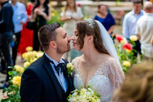 Intimate wedding ceremony moment captured in a lush garden with spring blooms.
