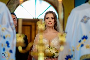 A wedding ceremony shot through golden candlelight with decorative blue details.