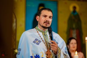 A priest in traditional Orthodox vestments conducts a religious service in a church setting.