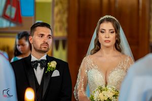 A traditional church wedding ceremony with elegant decorations and floral arrangements.