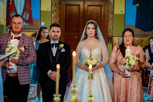 Wedding party members standing in formation during a traditional church ceremony.