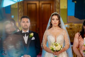 An elegant wedding ceremony with decorative lighting and formal attire.