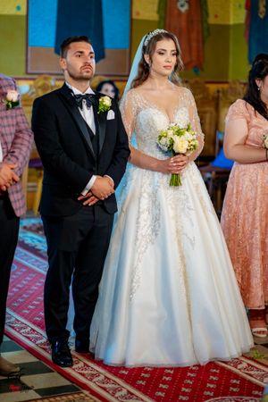 Wedding party standing during traditional orthodox church ceremony.