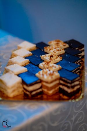 Elegant layered dessert bars arranged in alternating blue and white patterns.