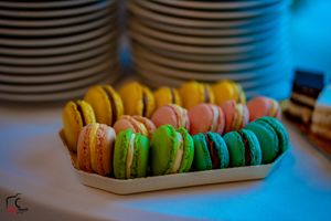 Colorful French macarons arranged in a row on a dessert table.