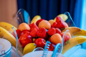 Fresh fruit display with strawberries and other colorful fruits on a catering table.