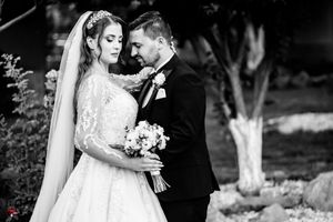 Black and white wedding portrait showcasing an intimate moment between newlyweds.