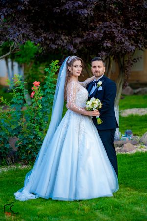 Elegant outdoor wedding photography featuring a beautiful garden backdrop and formal attire.