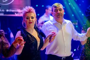 Elegant evening event with dancers enjoying themselves under theatrical lighting.