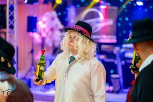 Party scene with dramatic lighting effects and festive atmosphere.