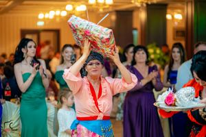 Elegant ballroom celebration with warm lighting and guests in formal wear.