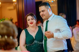 Elegant party scene with formal attire and ambient lighting creating a romantic atmosphere.