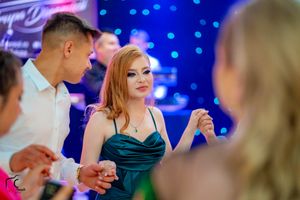 Wedding reception dance floor illuminated with blue lights and decorative lighting effects.