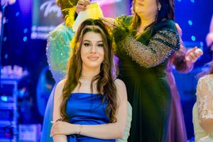 Evening celebration with guests in formal attire under colorful mood lighting.