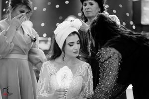 Black and white photo of wedding guests celebrating during an emotional reception moment.