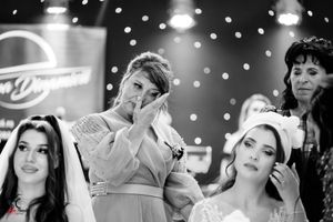 Black and white candid shots of wedding reception with guests celebrating under string lights.