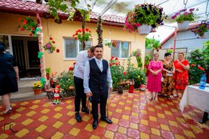 Festive outdoor celebration on a Mediterranean-style patio with bright floral decorations.