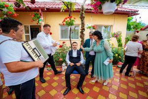 Outdoor party scene on Spanish-style patio with red tile roof and climbing flowers.