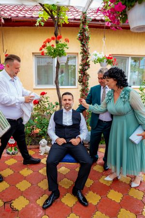 Wedding celebration on a Mediterranean courtyard with mint green accents and floral decor.