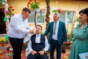 Outdoor party scene with guests enjoying music and conversation on a decorated terrace.