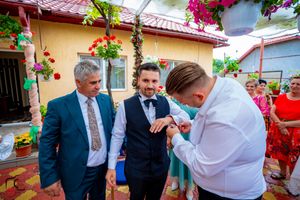 Wedding celebration in a vibrant garden patio with flowering vines and decorative elements.