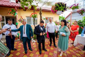 Lively celebration on tiled patio with hanging flowers and decorative garden elements.