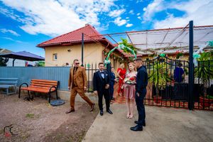 Panoramic view of an outdoor wedding venue with red roof and blue sky on a sunny day.