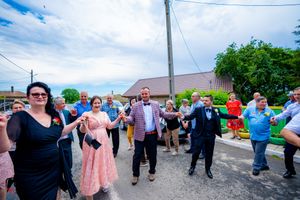 Group performing synchronized dance movements during an outdoor celebration.