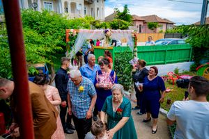 People dancing in formation at an outdoor party with decorative bunting overhead.