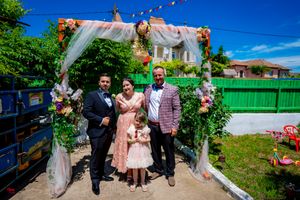Festive outdoor gathering space with colorful bunting and white fabric decorations.
