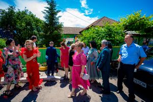 Crowd of people mingling at an outdoor event on a bright summer day.