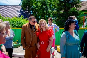 Wedding guests mingling outdoors at a casual daytime celebration.