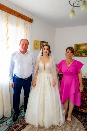 Wedding preparation scene in a cozy room with traditional decor.