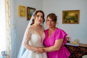 A heartfelt moment captured between two people hugging, with one wearing a white wedding dress.