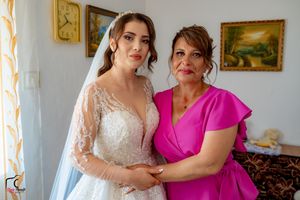 A touching pre-wedding scene with two people sharing an emotional moment in a decorated interior.